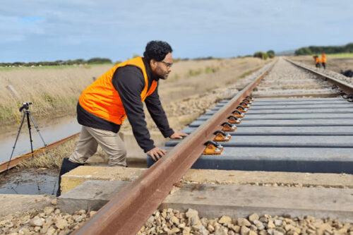 Dr Wahid Ferdous inspects the composite transoms installed on a part of the South Australian rail track.